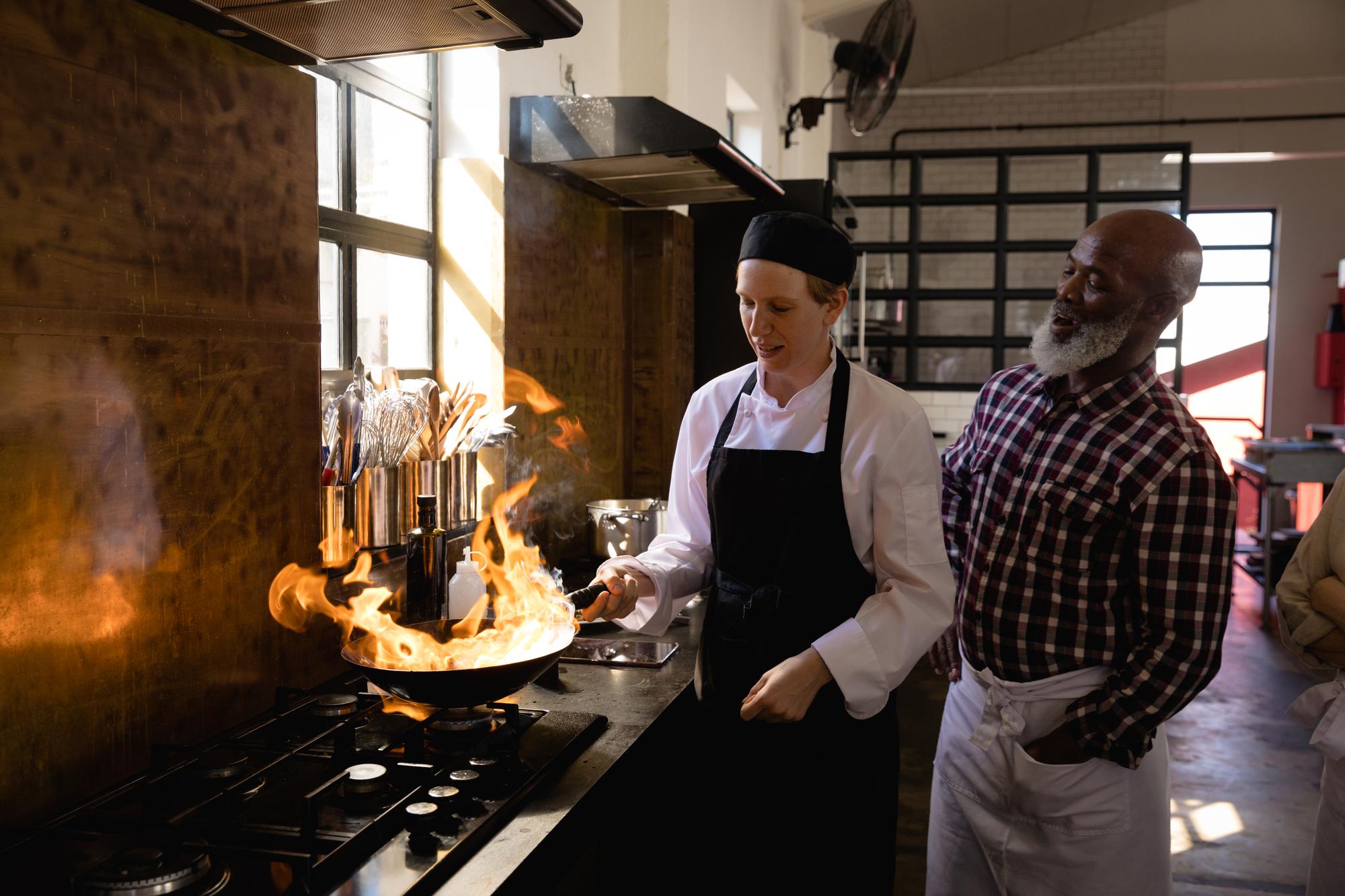 small restaurant kitchen with chef at stove